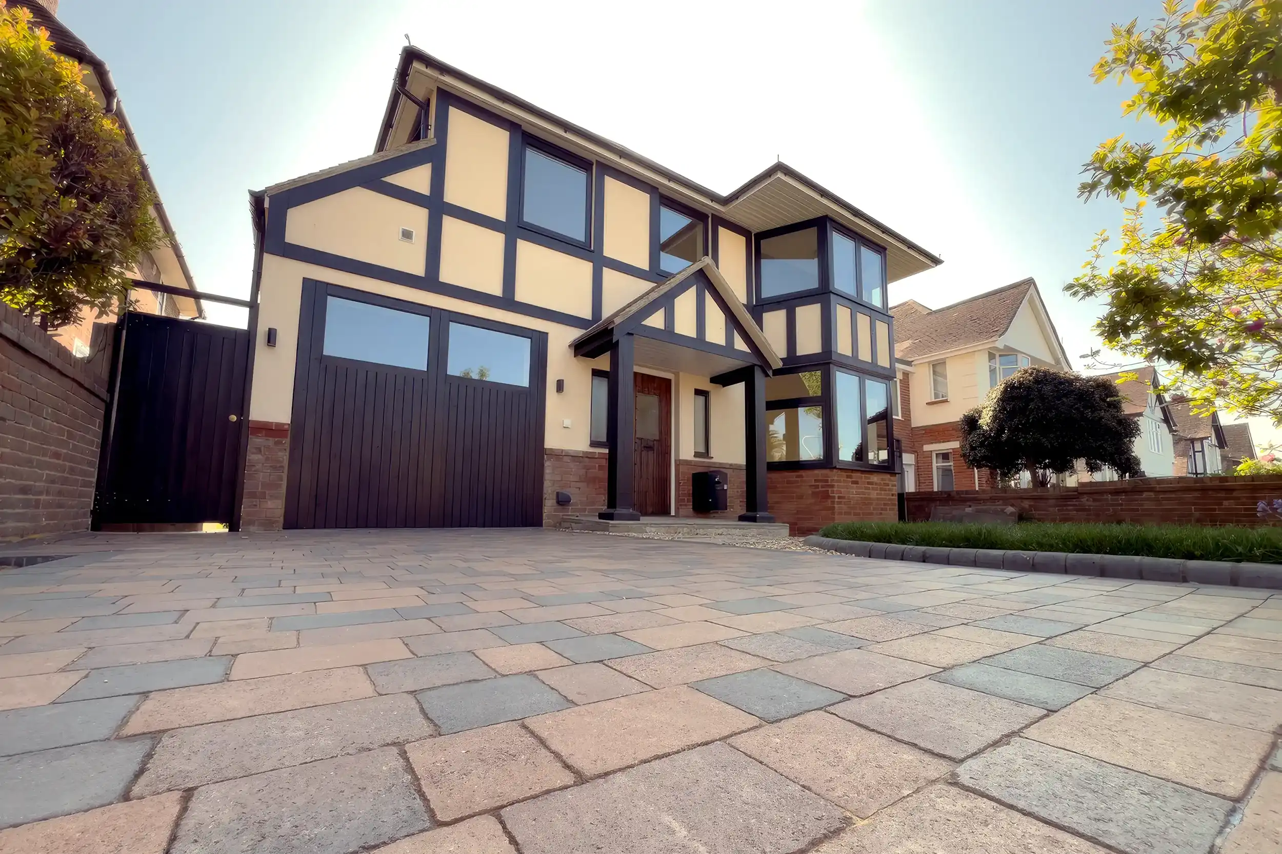 A large house with a large driveway in front of it.