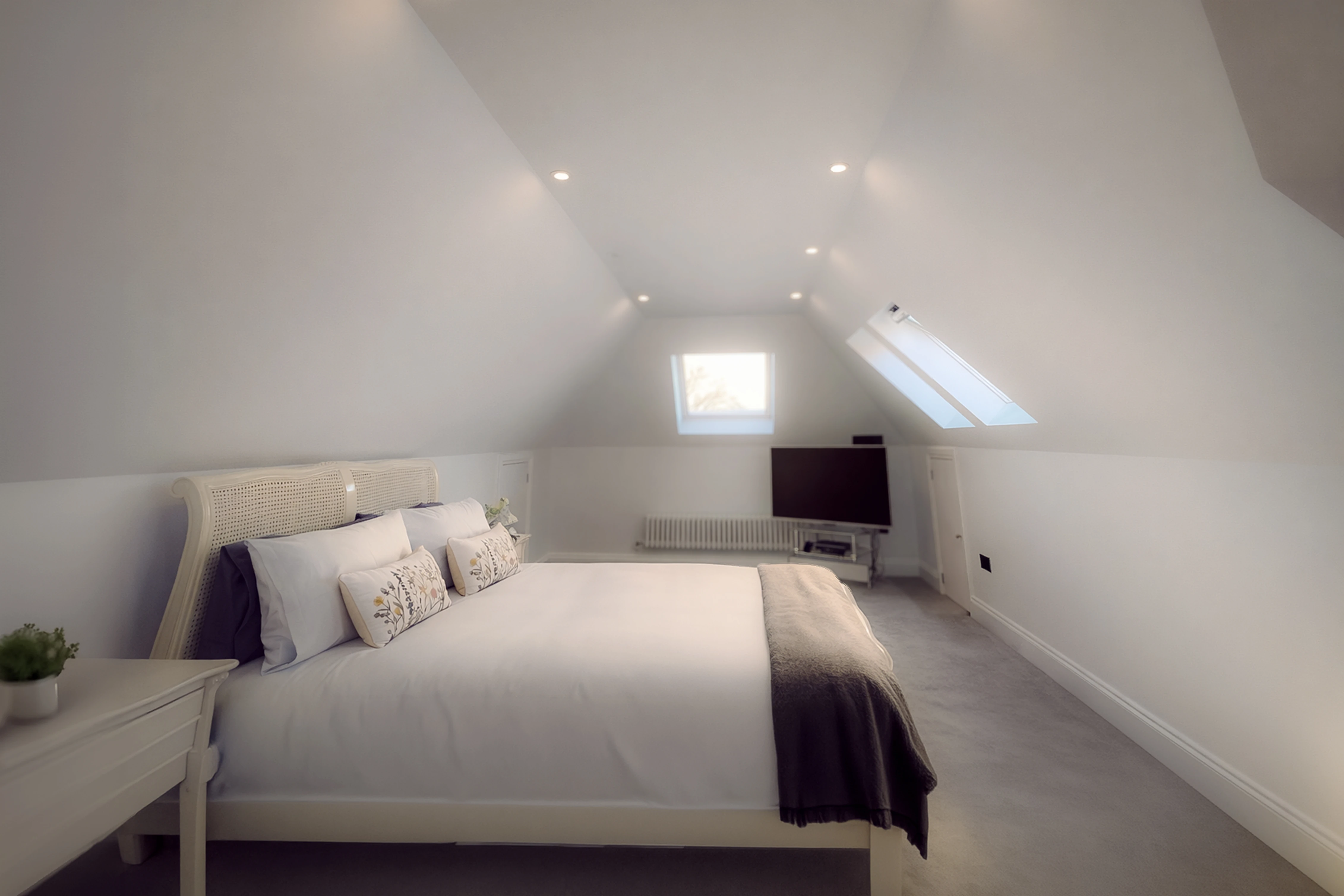 A bedroom with a bed, dresser, and television in it.